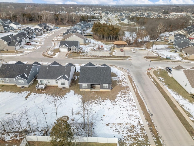 snowy aerial view featuring a residential view