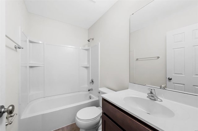 bathroom featuring toilet, shower / washtub combination, and vanity