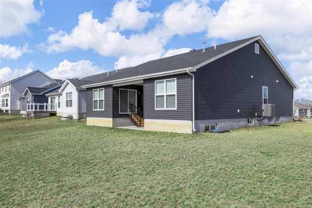 back of property featuring a lawn and entry steps