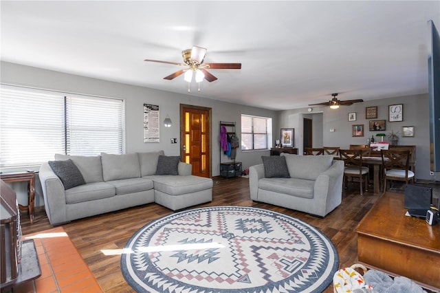 living room with ceiling fan and dark hardwood / wood-style flooring