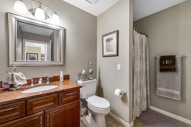 bathroom with vanity, tile patterned floors, and toilet