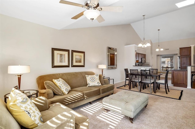 living room featuring light carpet, ceiling fan with notable chandelier, and high vaulted ceiling