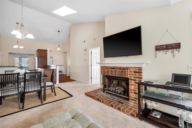 carpeted living room with a fireplace and high vaulted ceiling