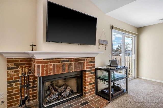 details with carpet and a brick fireplace