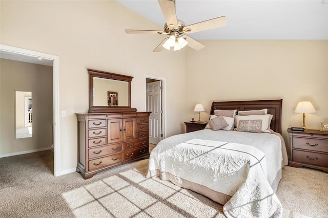 carpeted bedroom with ceiling fan and high vaulted ceiling