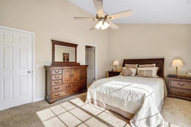 bedroom featuring vaulted ceiling, light carpet, and ceiling fan