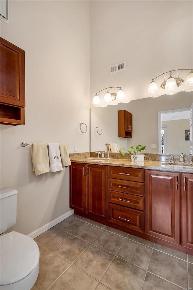 bathroom featuring vanity, toilet, and tile patterned flooring