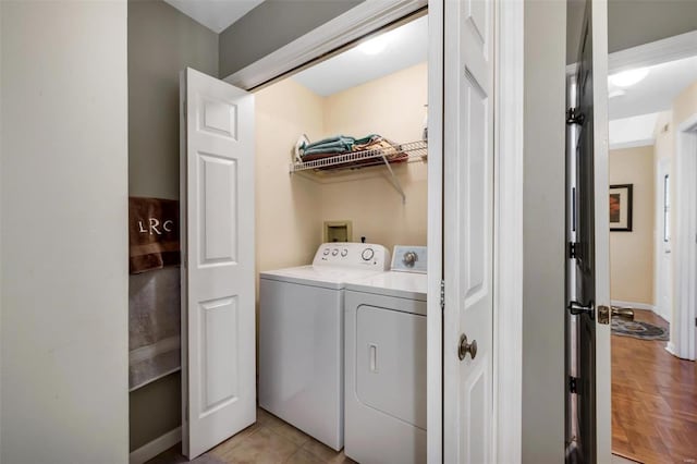 laundry room with washing machine and dryer and light parquet flooring