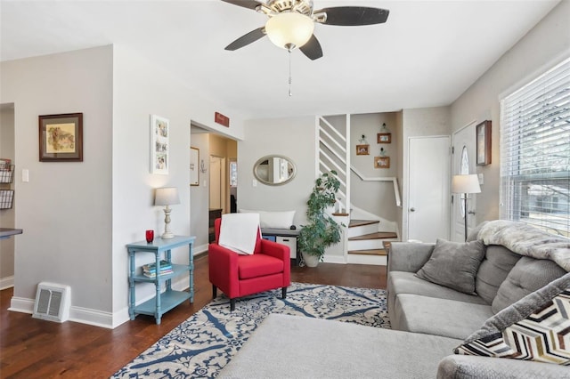 living room with dark wood-type flooring and ceiling fan