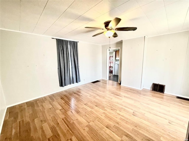 spare room with light hardwood / wood-style flooring, ornamental molding, and ceiling fan