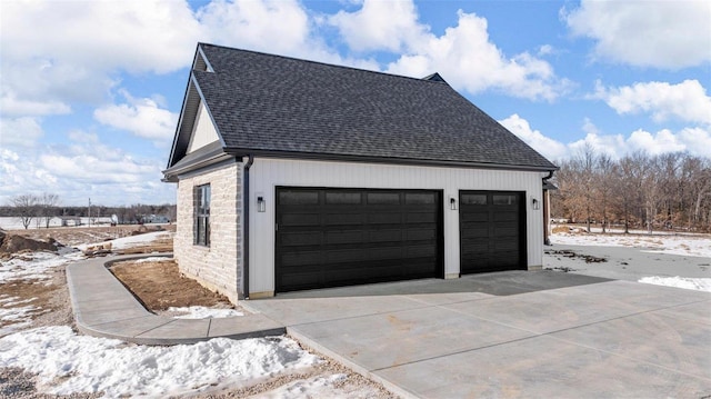 snow covered property featuring a garage