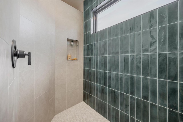 bathroom with a tile shower