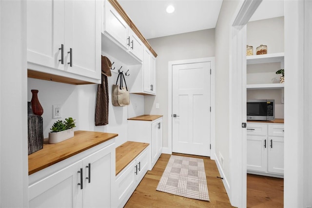 mudroom with light hardwood / wood-style floors