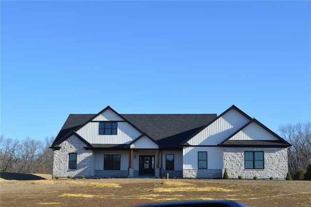 modern inspired farmhouse with stone siding and a shingled roof