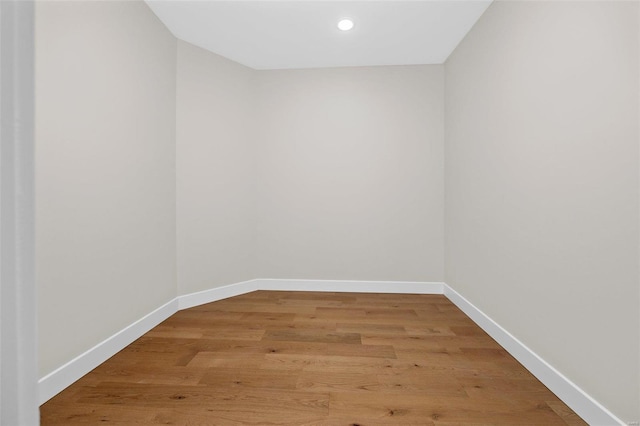 unfurnished room with recessed lighting, baseboards, and light wood-type flooring