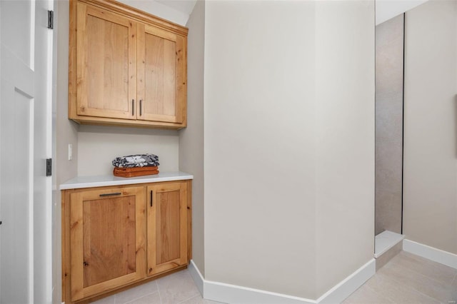 interior space with light tile patterned floors and baseboards