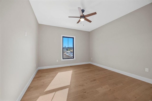 unfurnished room featuring baseboards, light wood-style floors, and ceiling fan