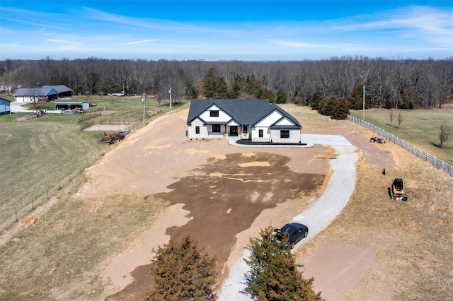bird's eye view featuring a view of trees and a rural view