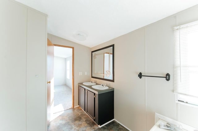 bathroom featuring lofted ceiling and vanity