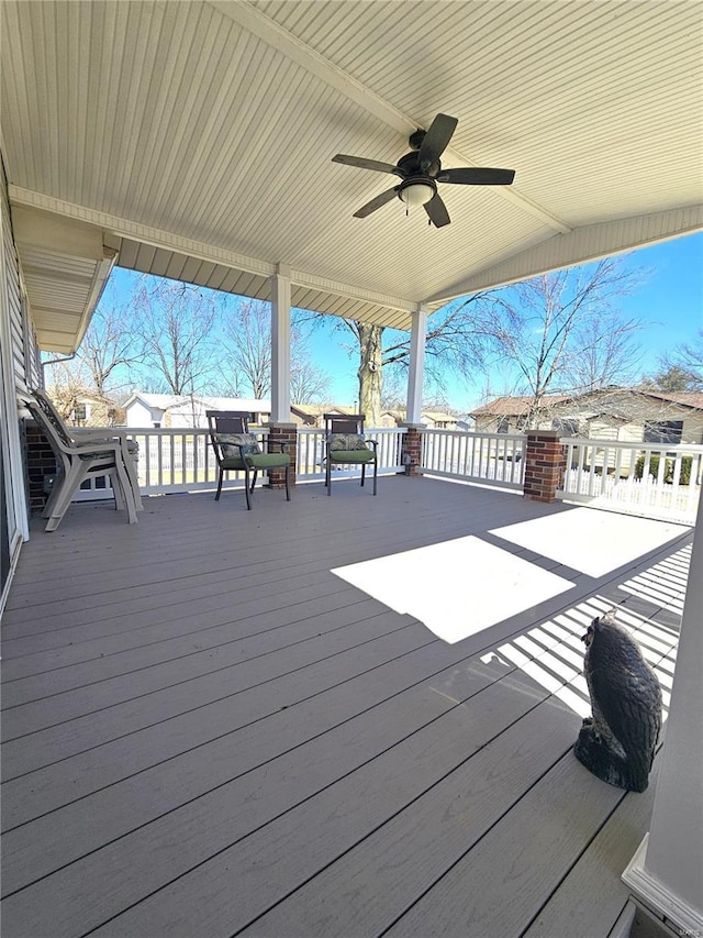 wooden deck featuring a ceiling fan