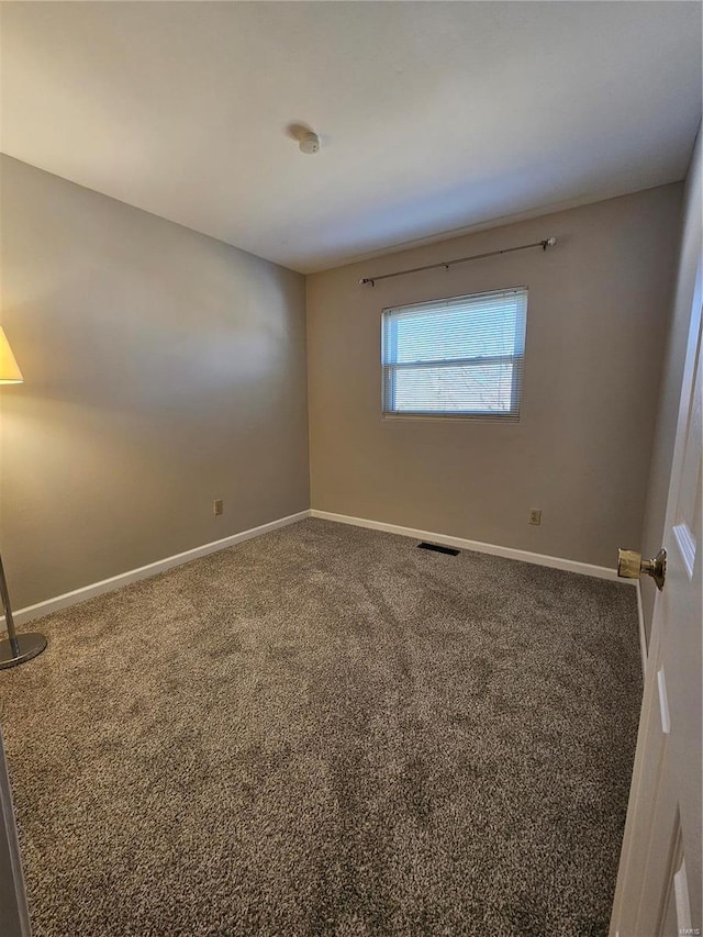 unfurnished room featuring baseboards, visible vents, and carpet floors