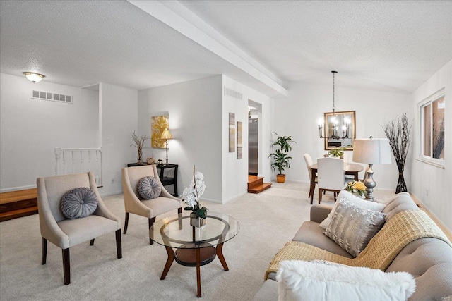 carpeted living room with an inviting chandelier, a textured ceiling, and lofted ceiling