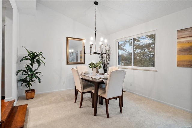 carpeted dining room featuring a chandelier and lofted ceiling