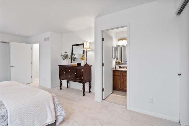 bedroom featuring sink and light colored carpet