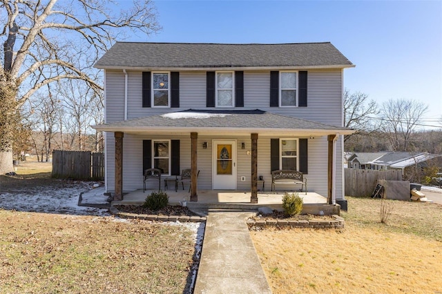 front facade with a porch and a front yard