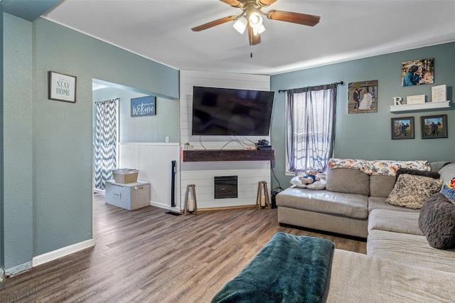 living room with wood-type flooring and ceiling fan