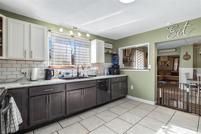 kitchen featuring dishwasher, white cabinetry, sink, light tile patterned flooring, and dark brown cabinets