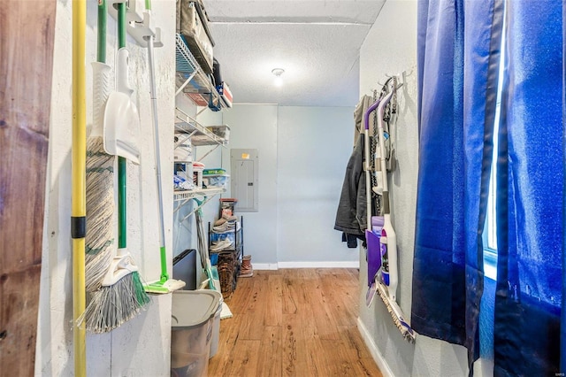 walk in closet with wood-type flooring and electric panel