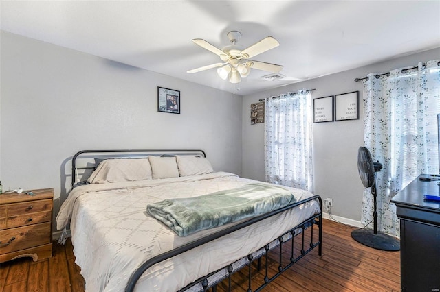 bedroom with ceiling fan and dark hardwood / wood-style flooring