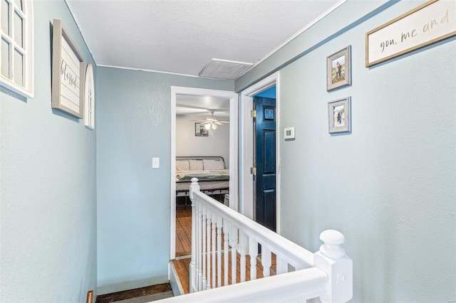 hallway featuring a textured ceiling