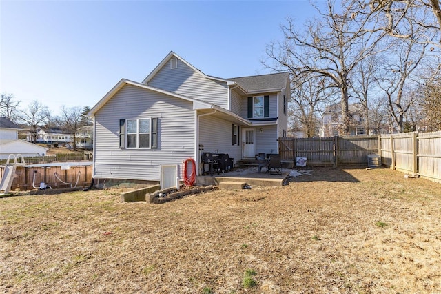 back of property with a lawn, a patio, and cooling unit