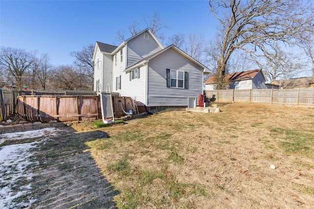 rear view of house featuring a lawn