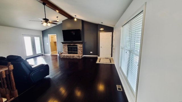 living room with a fireplace, french doors, ceiling fan, dark hardwood / wood-style floors, and lofted ceiling with beams