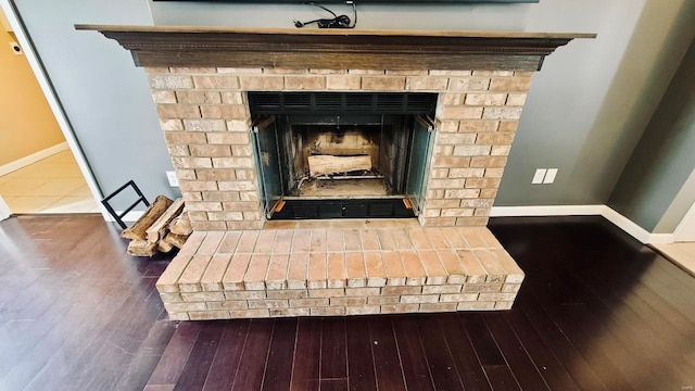 room details with a fireplace and hardwood / wood-style flooring