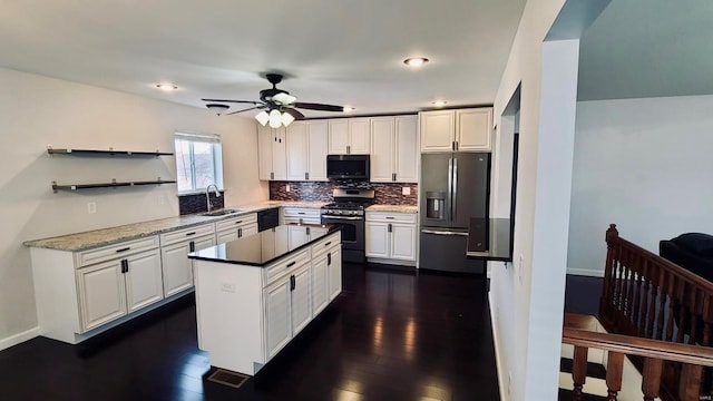 kitchen featuring white cabinets, a kitchen island, stainless steel appliances, sink, and dark hardwood / wood-style floors