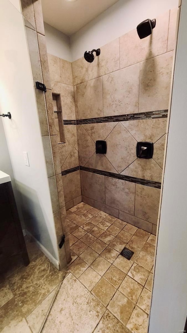 bathroom with tiled shower