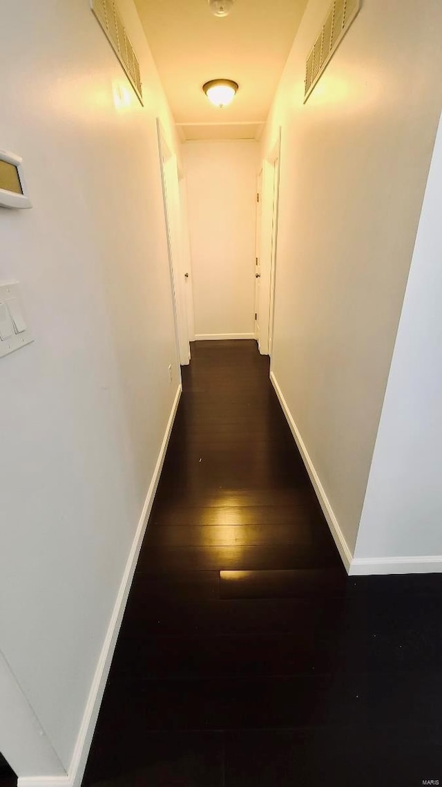 hall with dark wood-type flooring