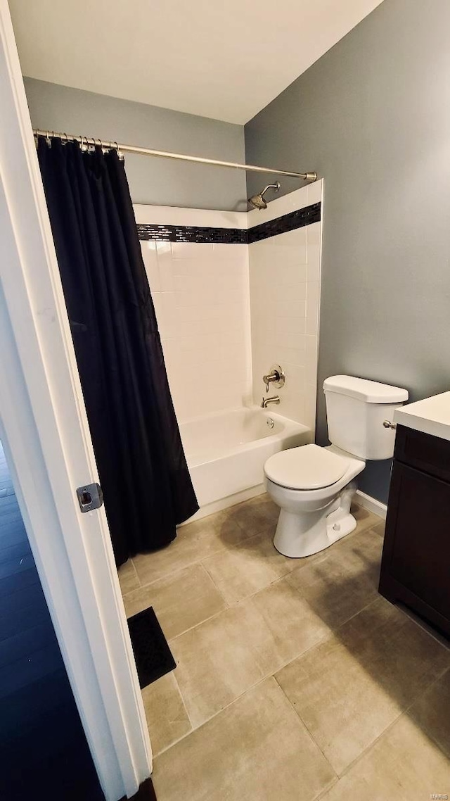 full bathroom featuring toilet, vanity, shower / tub combo, and tile patterned flooring