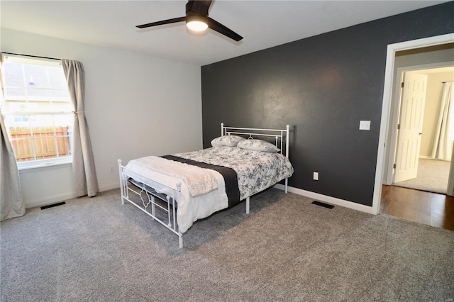 bedroom featuring ceiling fan and carpet