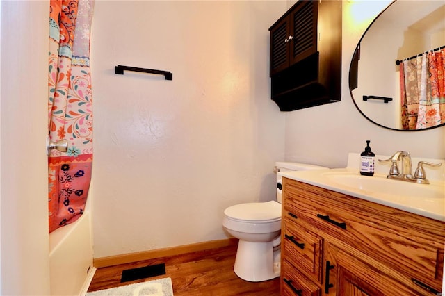 full bathroom with toilet, vanity, shower / tub combo, and hardwood / wood-style flooring