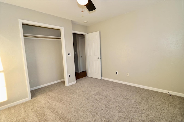 unfurnished bedroom with ceiling fan, a closet, and carpet floors