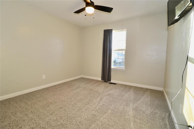 empty room featuring ceiling fan and carpet flooring