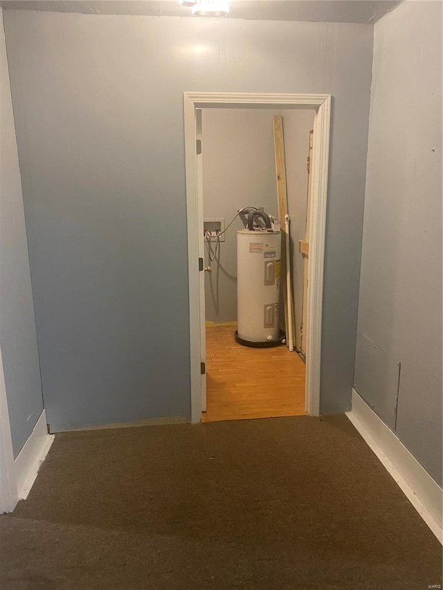 corridor featuring carpet floors and electric water heater