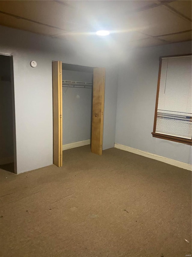 unfurnished bedroom with carpet floors and a closet