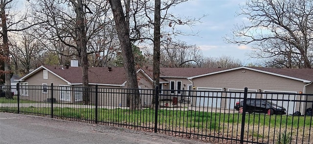 view of front of home with a front yard and a garage