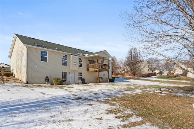 snow covered property featuring a balcony